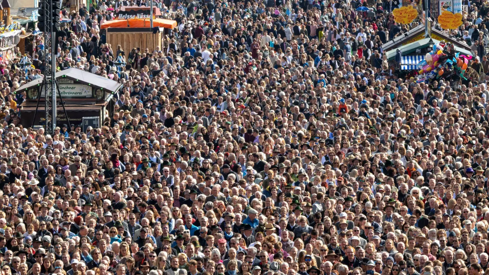 Dicht drängen sich die Wiesn-Gäste beim Platzkonzert zwischen den Zelten und Fahrgeschäften. (Bild: Peter Kneffel/dpa)